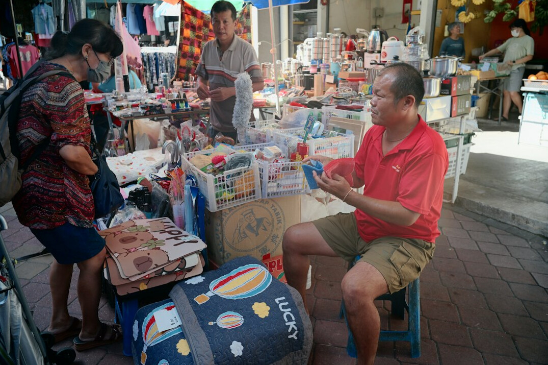 Outdoor market stall with vendor and customer