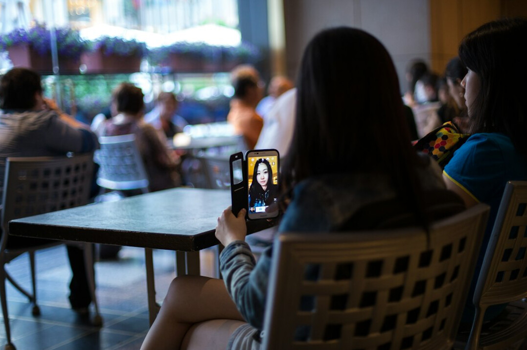 Two people having a recorded conversation at a table
