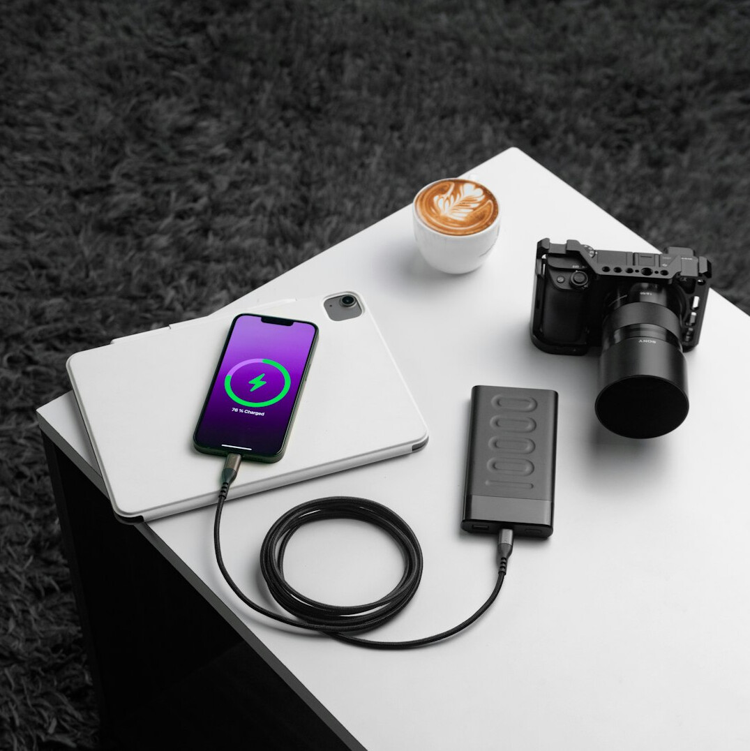 Open notebook and camera on a wooden desk