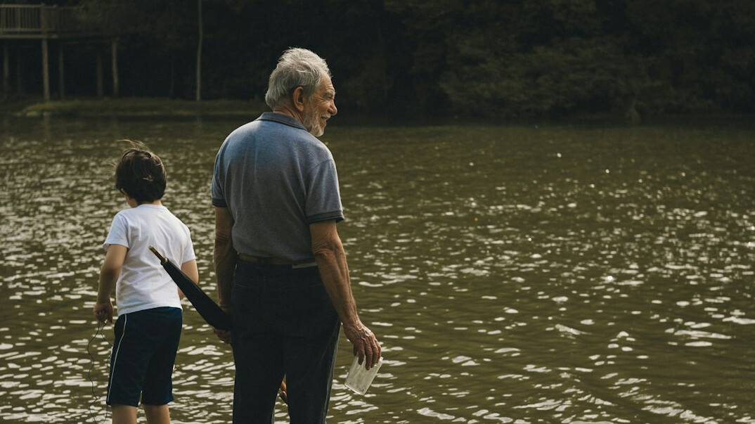 Grandfather and grandson walking together outdoors